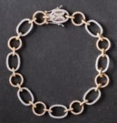 A tricolour, 18ct gold, diamond bracelet, the links alternately circular and ovoid,