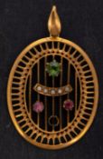 An oval, openwork pendant in the Suffragette colours, set with seed pearls,