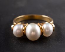 A graduated, cultured pearl, three-stone ring,