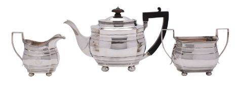 A George V three piece silver tea service, maker Frazer and Haws, London 1922, of barge form,
