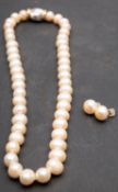 A single-row, cultured pearl necklace and pair of cultured button pearl ear studs,