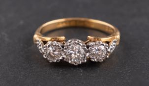 An 18ct gold, round, brilliant-cut diamond three-stone ring, total estimated diamond weight ca. 0.