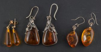 Three pairs of amber drop earrings,