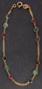 A flattened, curb-link, spectacle-set emerald, sapphire and red spinel bracelet, stamped '18K',