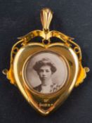 An Edwardian, 9ct gold heart-shaped locket pendant, with glazed compartments to front and verso,