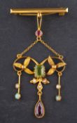 A gemset girondelle brooch, with floral motifs and including peridot, opal,