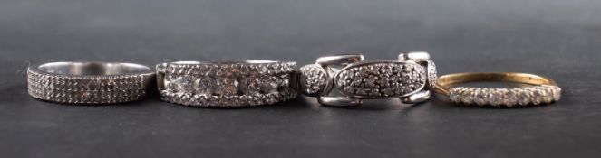Four diamond rings, including a ring marked '9K', total diamond weight marked '0.