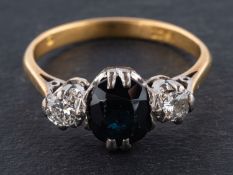 An oval, mixed-cut sapphire and round, brilliant-cut diamond three-stone ring,
