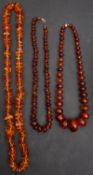 Three amber bead necklaces, including a necklace with amber beads of yellowish orange hue,