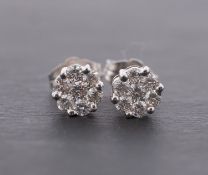A pair of 9ct gold, round, brilliant-cut diamond ear studs, of flowerhead design,