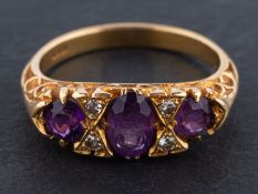 An oval, mixed cut amethyst ring, with single-cut diamond spacers,