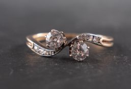 An old-cut diamond cross-over ring, estimated weight of principal diamonds ca. 0.