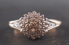 A 9ct gold, diamond cluster ring, total estimated diamond weight 0.20ct, length of ring head ca. 1.