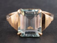 An octagonal, step-cut aquamarine ring, with stepped shoulders, estimated aquamarine weight ca. 5.