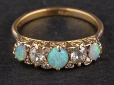 An old-cut diamond and cabochon-cut opal ring, with rose-cut diamond spacers,