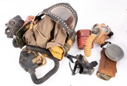 A WWII Infant gas mask, dated 1939, together with four other various WWII and later gas masks.