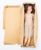 An early 20th century German bisque head doll, applied black wig, sleeping eyes,