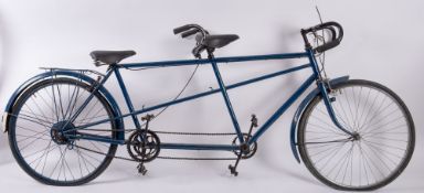 A vintage Colibri Cycles tandem bicycle, blue frame with drop handle bars, cable brakes,