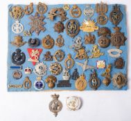 A collection of various regimental cap badges, including 23rd Royal West Fusiliers,