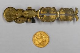 A Victorian sovereign 1895, together with a Harrison brass sovereign scale.
