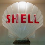 A Shell double sided glass petrol pump globe, maker Hailware, red text on a moulded body,