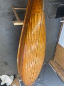 An early 20th century Canadian cedar strip canoe: of traditional construction with three seats,