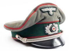 A German Army Artillery Officers Cap, green with red piping and black peak, silver cord,
