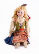 A 19th century continental bisque head doll in 'Sverigedrakten', applied blonde wig,