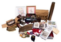 A collection of various militaria, including stable belts, a gas mask in canvas bag,