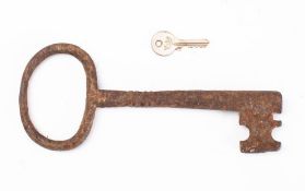 An early steel key: with plain oval bow, two section barrel with pipe end, 24cm long.