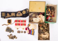 A collection of various militaria comprising buttons, cap and shoulder badges,