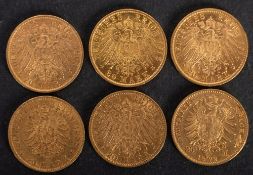 Six German gold coins comprising 20 mark pieces.