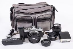 An Olympus OM-1 35mm SLR camera, serial number 1634604, fitted Olympus 50 mm lens ,