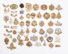 A collection of fifty five British regimental cap and shoulder badges,