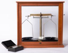A mahogany cased chemical balance, together with a cased set of weights.