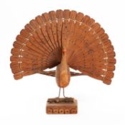 A WWII German POW wooden model of a peacock, 26cm high.