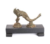 A large 19th century brass dolphin door knocker and anvil: later mounted on a wooden plinth,
