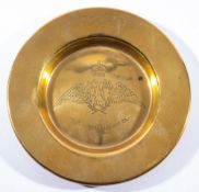 A brass ashtray with Royal Flying Corps insignia, 15 cm diameter.