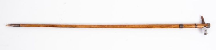 A WWI German trench art walking cane, the ash shaft with copper ferrules and bullet handle,