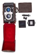 A Yashica 365 twin lens reflex camera together with a film size adapter.