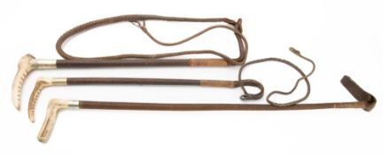 Three antler handled leather bound riding whips,