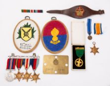 A group of five WWII medals, together with a brass kit bag name plate, a leather vambrace, etc.