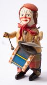 A Schuco Clockwork Clown, with painted face and red scarf,