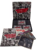 A small collection of LPs 45s and CDs by The Beatles and The Rolling Stones.