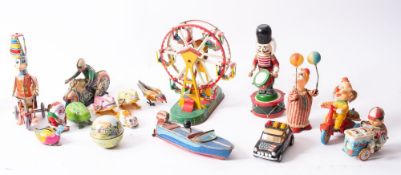 An unboxed group of tinplate and other mechanical toys, mainly German and Japanese, 20th century.