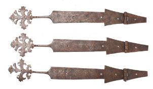 A set of three iron strapwork hinges,