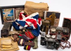 A collection of various militaria, including two field telephones, one with morse key to top,