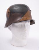 A WWI period German M1916 Stahlhelm, hand painted camouflage finish with brown leather liner,