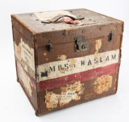 Four pairs of Indian chappal or jutti shoes, together with four pith helmets in a canvas trunk.
