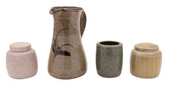 *David Leach [1911-2005] a porcelain jar and cover with exterior ribbed decoration on a mustard